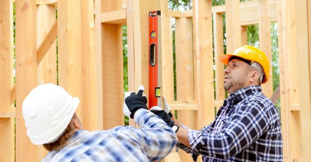 general contractor with framing level